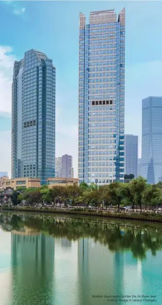  ??  ?? Modern skyscraper­s border the Jin River near Anshun Bridge in central Chengdu