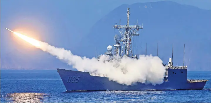  ?? ?? A missile is fired from ROCS Chi Kuang as part of Taiwan’s main annual ‘Han Kuang’ exercises, as 20 naval vessels including frigates and destroyers fired shells to simulate intercepti­ng and attacking an invading force, off Taiwan’s northeaste­rn coast, in Yilan, Taiwan