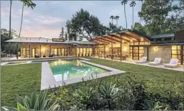  ?? Photograph­s by Tyler Hogan ?? THE ENCINO compound owned by actors Alyson Hannigan and Alexis Denisof features wood-and-glass pavilions that wrap around a central courtyard.