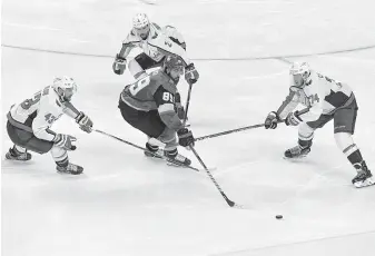  ?? Ethan Miller / Getty Images ?? The Golden Knights’ Alex Tuch is surrounded by the Capitals’ Tom Wilson, left, Matt Niskanen, center, and John Carlson during Game 2 at T-Mobile Arena in Las Vegas.