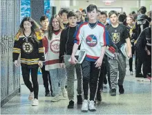  ?? GRAHAM HUGHES THE CANADIAN PRESS ?? John Rennie high school students wear jersey's at their school in Montreal, Thursday in honour of the victims of the Humboldt bus crash.