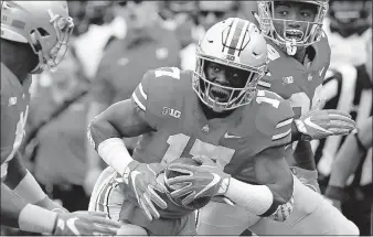  ?? [BROOKE LAVALLEY/DISPATCH] ?? Linebacker Jerome Baker, middle, has size and speed that likely will prove enticing to NFL teams. PLAYER