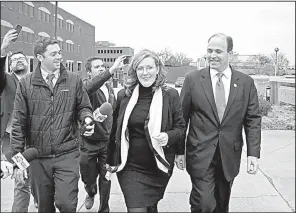  ?? AP/The Daily Press/JONATHON GRUENKE ?? Virginia Delegate David Yancey (right) walks with his campaign manager, Gretchen Heal, outside the Newport News, Va., courthouse where a three-judge panel ruled that the race between the Republican candidate and Democratic rival Shelly Simonds was a tie.