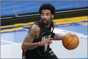  ?? FRANK FRANKLIN II - THE ASSOCIATED PRESS ?? FILE - Brooklyn Nets’ Kyrie Irving moves the ball during the first half of an NBA basketball game against the Cleveland Cavaliers Sunday, May 16, 2021, in New York.