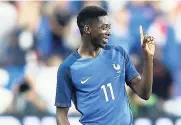  ?? AP ?? France’s Ousmane Dembele reacts after scoring his side’s third goal during a friendly match between France and England at the Stade de France in Saint-Denis, Paris, yesterday.