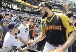  ?? Jae Hong Associated Press ?? DODGERS CLOSER Kenley Jansen greets a fan before the start of the home run derby. Jansen, a first-time All-Star, will be a free agent after the season.