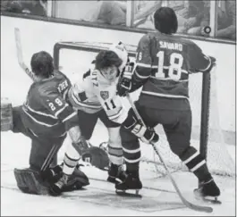  ?? CANADIAN PRESS FILE PHOTO ?? Montreal Canadiens goalie Ken Dryden and defender Serge Savard have Bruins’ Bob Schmautz bottled up as they watch the puck clear the top of the net during second-period Stanley Cup playoff action in Boston Garden on May 14, 1977.