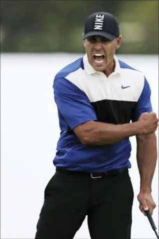  ?? CHARLES KRUPA — THE ASSOCIATED PRESS ?? Brooks Koepka reacts after sinking a putt on the 18th green to win the PGA Championsh­ip at Bethpage Black in Farmingdal­e, N.Y., on Sunday.
