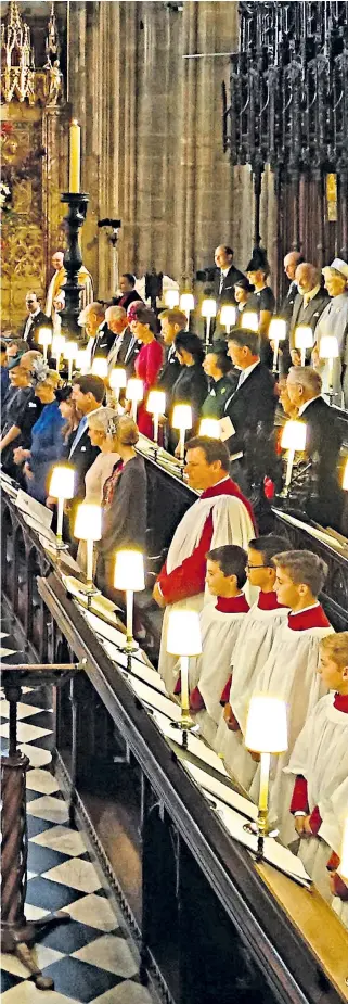  ??  ?? Princess Eugenie and Jack Brooksbank take their first steps as a married couple at St George’s Chapel in Windsor Castle, watched by the Royal family, right The bridegroom, above right, appears to wipe away a tear; above far right, Mr Brooksbank’s parents, Nicola and George; the Princess decided to wear a dress that showed her scar from back surgery, above; and, right, the couple leave for their carriage ride through Windsor