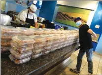  ?? Courtesy photo ?? Sushi 661 owner David Song Cho and his staff prepare 415 sushi rolls (above) for donation to Henry Mayo Newhall Hospital. Cho later donated 200 Honolulu poke bowls (left) to Kaiser Permanente.