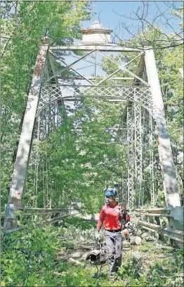  ?? [BARBARA J. PERENIC/DISPATCH] ?? Tracy Nethers works for a tree service that helped take out brush from a 132-year-old bridge in Pickaway County.