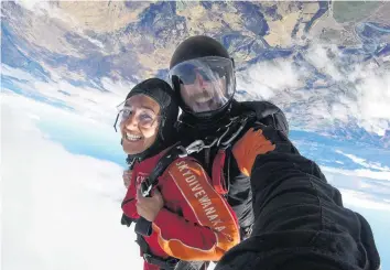  ?? PHOTO CREDIT: SUPPLIED ?? Welcome to my office . . . Wanaka Skydive tandem master Sam Bishop with customer Maria Manwani upside down and on top of the world.