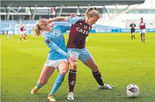  ?? JAMES GILL DANEHOUSE VIA GETTY IMAGES ?? Aston Villa’s Natalie Haigh holds off a challenge from Manchester City’s Chloe Kelly during a Women's Super League match in Manchester on Sunday.