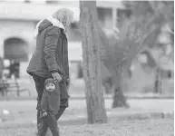  ?? AAMAQ NEWS AGENCY VIA AP ?? A veiled child walks through a park in Raqqa, Syria. An estimated 300,000 people are trapped in the city, living in terrifying uncertaint­y over how to find safety.