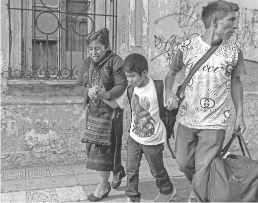  ?? PHOTOS BY NICK OZA/THE REPUBLIC ?? Another child deported from the United States and reunited with his parents walks out of the shelter in Guatemala City on Tuesday.