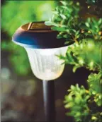  ??  ?? Solar landscape lights can be used to outline the perimeter of an outdoor living space.