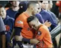  ?? DAVID J. PHILLIP — THE ASSOCIATED PRESS ?? Houston’s Jose Altuve (27) celebrates with George Springer (4) after they scored on teammate Carlos Correa’s double Friday in Houston.