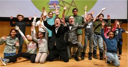  ?? KATE GILBERT ?? James Kennedy (center, left) at the 90-Second Newbery Film Festival at the Boston Public Library in 2019.