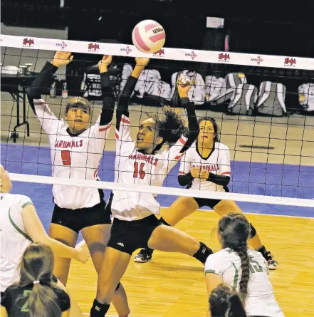  ?? JANE PHILLIPS/FOR THE NEW MEXICAN ?? Robertson’s Jazmyne Jenkins, left, and Alianza Darley, center, return a volley against Moriarty on Friday during a Class 4A State Volleyball Tournament semifinal match in the Santa Ana Star Center. Robertson won to advance to the final.