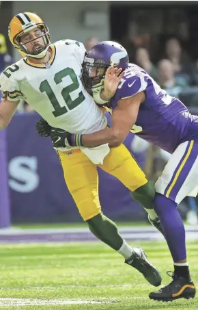  ?? MARK HOFFMAN / MILWAUKEE JOURNAL SENTINEL ?? Packers quarterbac­k Aaron Rodgers is hit by Vikings linebacker Anthony Barr, breaking Rodgers’ collarbone during their game Oct. 15 at U.S. Bank Stadium. The Vikings won both meetings with the Packers last season.