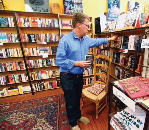  ?? ARIC CRABB/STAFF ?? Owner Michael Barnard pours his passion for literature into his Danville shop, Rakestraw Books.