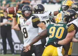  ?? The Canadian Press ?? Hamilton Tiger-Cats quarterbac­k Jeremiah Masoli (8) prepares to pass against the Edmonton Eskimos during first-half CFL action in Edmonton on Friday night.