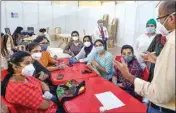  ??  ?? Medics attend a meeting at the newly prepared open-ground quarantine and isolation facility with 1,008 beds for semi-critical coronaviru­s patients, at BKC in Mumbai, on Monday