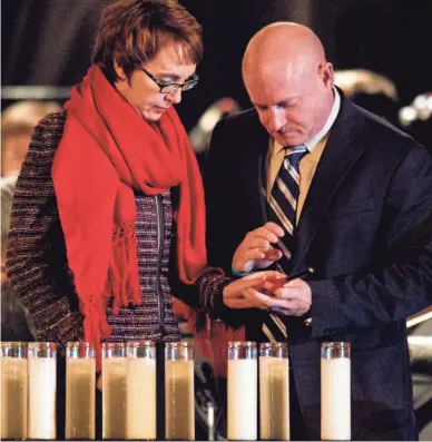  ?? ROB SCHUMACHER/THE REPUBLIC ?? Then-Rep. Gabrielle Giffords and her husband, Mark Kelly, attend a candleligh­t vigil in 2012.