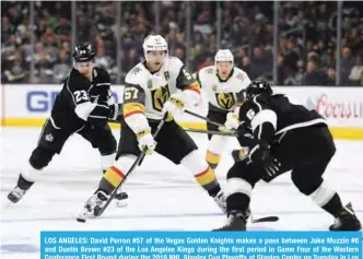  ?? — AFP ?? LOS ANGELES: David Perron #57 of the Vegas Golden Knights makes a pass between Jake Muzzin #6 and Dustin Brown #23 of the Los Angeles Kings during the first period in Game Four of the Western Conference First Round during the 2018 NHL Stanley Cup...