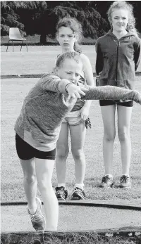  ?? Photograph­s: PAUL COHEN ?? Holly Cassidy hurls the shot put;