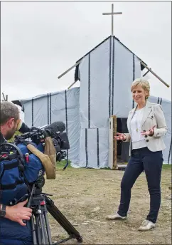  ??  ?? SHOW OF FAITH: The Songs Of Praise presenter Sally Magnusson filming outside the migrants’ makeshift church in the Calais camp