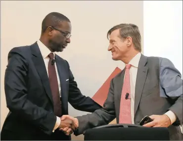  ?? PHOTO: REUTERS ?? Credit Suisse outgoing chief executive Brady Dougan (right) and Tidjane Thiam shake hands after news conference on Tuesday. Credit Suisse has swooped on Prudential boss Thiam to replace Dougan.