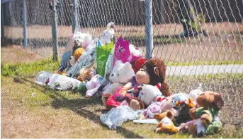  ??  ?? HEART-BREAKING: Tributes to the dead toddlers outside the family property near Brisbane.