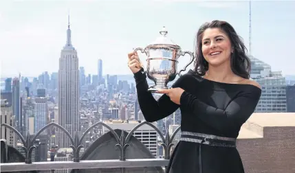  ?? AFP ?? Canada’s Bianca Andreescu poses with the US Open trophy at the Top of the Rock at Rockefelle­r Center in New York last year.