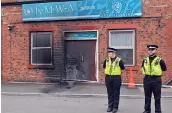  ??  ?? The main door of the Jamia Masjid Abu Huraira Mosque on Hardy Street, Beeston, had been set on fire at about 3: 45 am ( BST) on Tuesday. Poicemen guard the mosque.