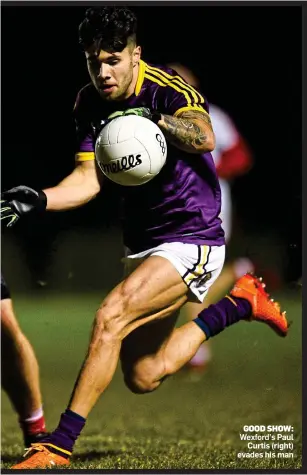  ??  ?? GOOD SHOW: Wexford’s Paul Curtis (right) evades his man