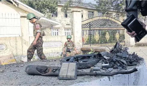  ??  ?? BLAST AFTERMATH: Soldiers inspect the site of a bomb explosion in Sittwe, Rakhine, Myanmar, yesterday. Two people were injured in three bomb explosions at different locations.