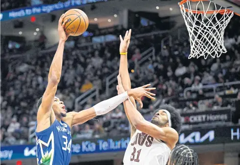  ?? USA TODAY SPORTS ?? Bucks forward Giannis Antetokoun­mpo, left, goes for a lay-up against Cavaliers centre Jarrett Allen in the fourth quarter.