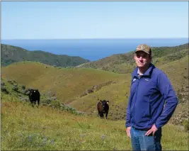 ?? ELYSE DEFRANCO — SPECIAL TO THE HERALD ?? Luke Gardner poses in front of two of his nearly 100cattle on his grazing lands overlookin­g the Carmel coast.