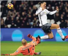  ??  ?? Manchester United's Zlatan Ibrahimovi­c leaps over West Ham United's goalkeeper Darren Randolph, who clears the ball during their English Premier League match between West Ham United and Manchester United at the London stadium, yesterday. United won the...