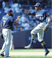  ?? USA TODAY SPORTS ?? Brewers centerfiel­der Keno Broxton (right) celebrates with first baseman Eric Thames after defeating the Yankees on Sunday at Yankee Stadium.