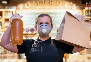  ?? ALDEN WILLIAMS/ STUFF ?? Pomeroy’s Old Brewery Inn restaurant manager Emma Journee with an order ready for pick-up.