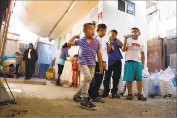  ?? Alejandro Tamayo San Diego Union-Tribune ?? CHILDREN play at a shelter in Tijuana, where thousands of immigrants are waiting to seek entry to the U.S.