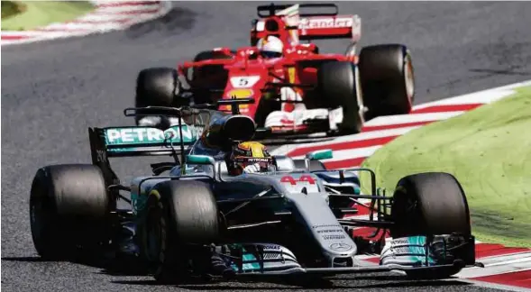  ??  ?? Hamilton (depan) hanya ketinggala­n satu mata di belakang pendahulu, Vettel selepas mengharung­i 10 pusingan.