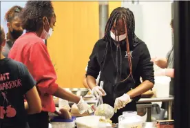  ?? ?? Wright Tech School students Sierra Victor and Zenaya Dixon, right, prepare cookies at The Wright Bean on Friday.