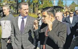  ?? Dania Maxwell Los Angeles Times ?? GOV. GAVIN Newsom, center, takes a tour of Century Villages at Cabrillo, an affordable housing developmen­t, with Long Beach Mayor Robert Garcia, right.