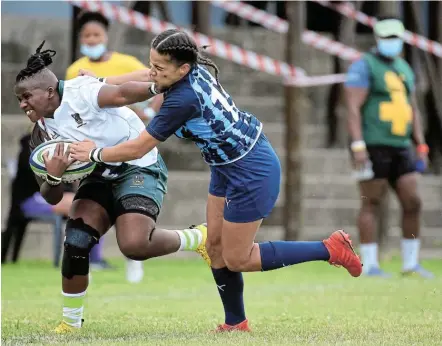  ?? Picture: SINO MAJANGAZA ?? POWER STRUGGLE: Lusanda Dumnke of Border is tackled by Layla Arrison of the Blue Bulls in their SA Women’s Premier Division fixture at Police Park in East London on Saturday.