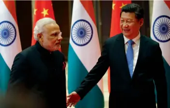  ?? AFP ?? A file photo of China’s President Xi Jinping (right) welcoming Prime Minister Narendra Modi during his visit to China —