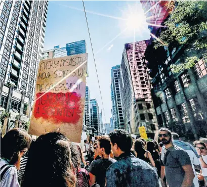  ?? ANDREW FRANCIS WALLACE TORONTO STAR ?? Crowds march through the streets of Toronto during an internatio­nal day of climate action on Friday.