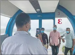  ??  ?? Ganesan Thivagar (second from right) poses for a photo with fellow migrant workers on the Singapore Flyer Ferris Wheel in Singapore. Thivagar and his co-workers are among at least 20,000 migrant workers who will be treated to rides by members of the public and businesses.